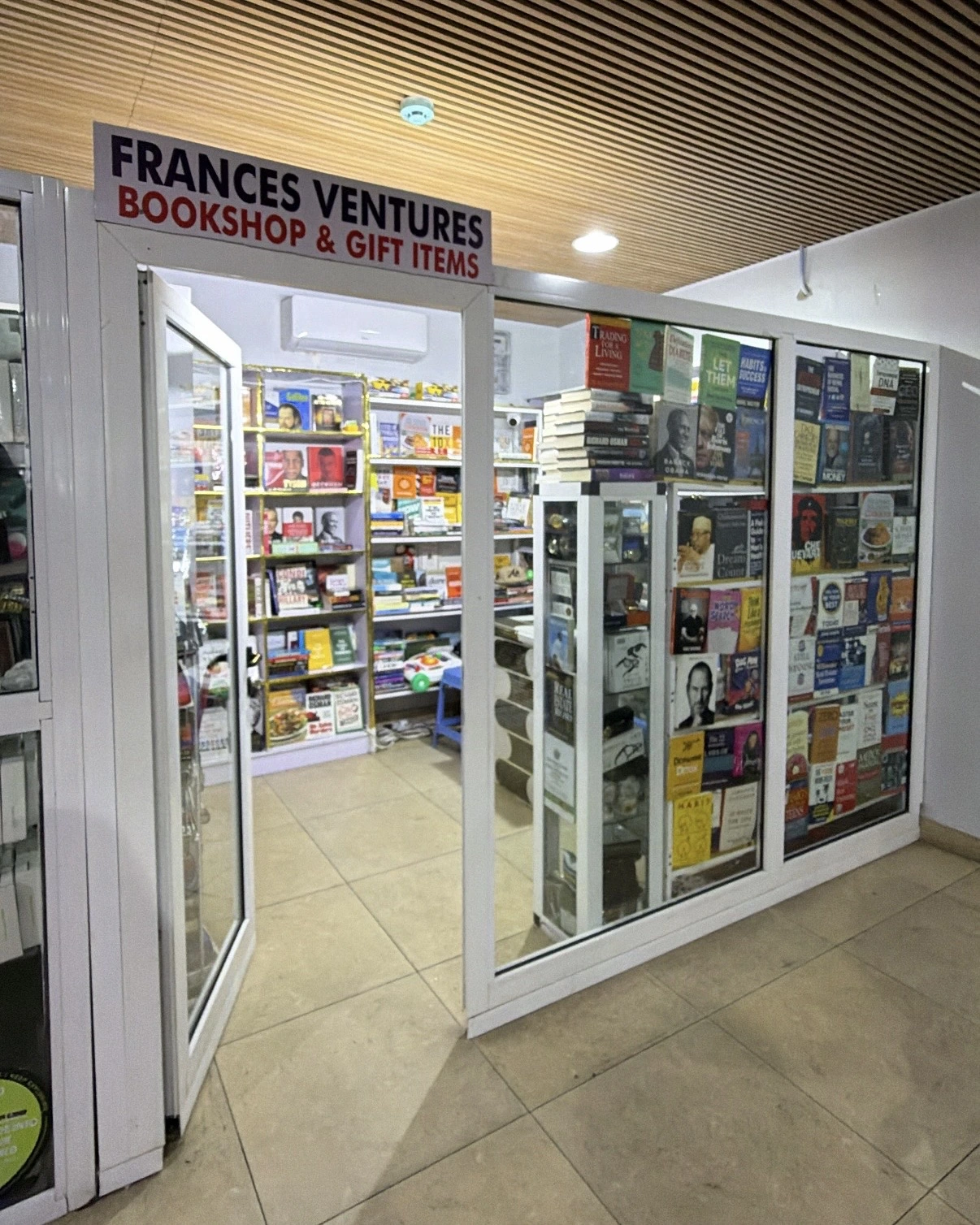 Francess Ventures bookshop entrance, with books displayed behind glass doors and the shop sign above.
